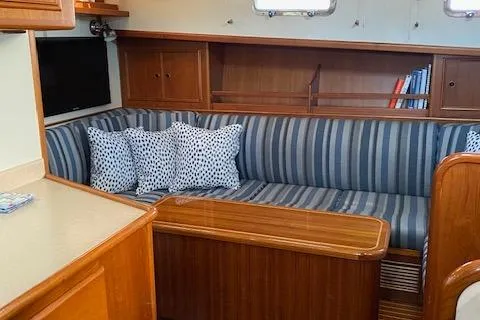 Slide: The Image of Interior of 2001 Grand Banks 49 Eastbay SX with striped seating and wooden cabinetry. - 18