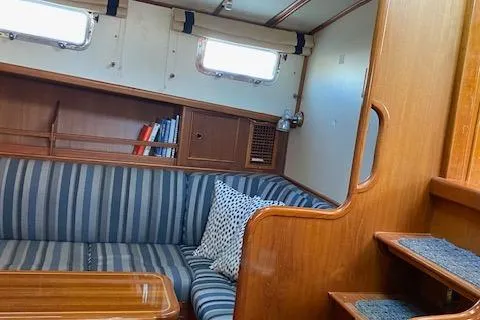 Slide: The Image of Interior of 2001 Grand Banks 49 Eastbay SX yacht with striped seating and wooden accents. - 19