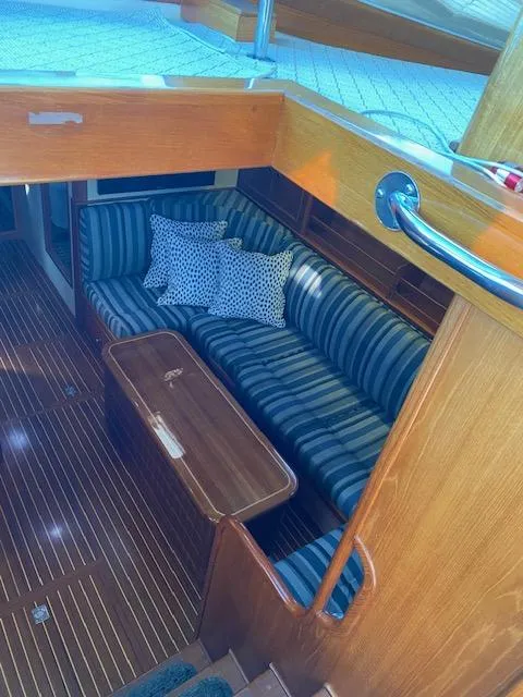 Slide: The Image of Interior of 2001 Grand Banks 49 Eastbay SX with striped seating and wooden finishes. - 21