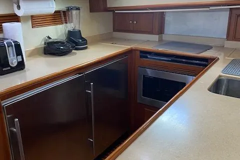 Slide: The Image of 2001 Grand Banks 49 Eastbay SX yacht kitchen with modern appliances and wood cabinetry. - 22