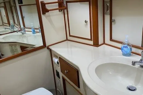 Slide: The Image of Luxurious bathroom in 2001 Grand Banks 49 Eastbay SX yacht with sink and mirror. - 25