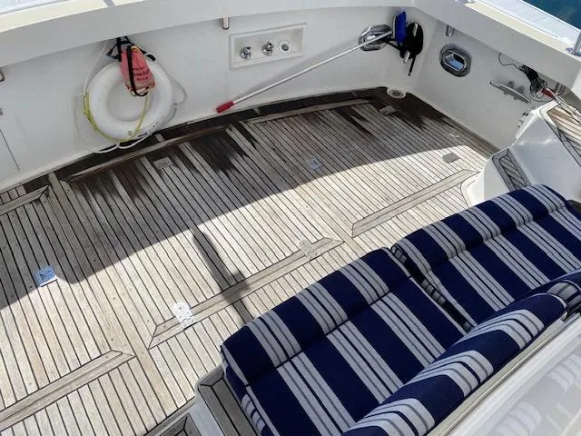 Slide: The Image of Teak deck of 2001 Grand Banks 49 Eastbay SX with striped seating and safety equipment. - 28