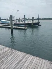 Slide: The Image of 2001 Grand Banks 49 Eastbay SX docked at a marina on a cloudy day. - 3