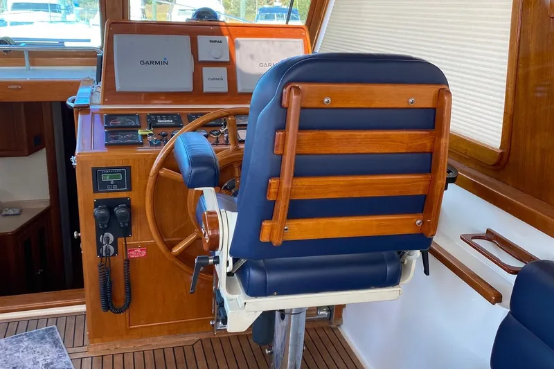 Slide: The Image of 2001 Grand Banks 49 Eastbay SX helm with wooden steering wheel and navigation equipment. - 6