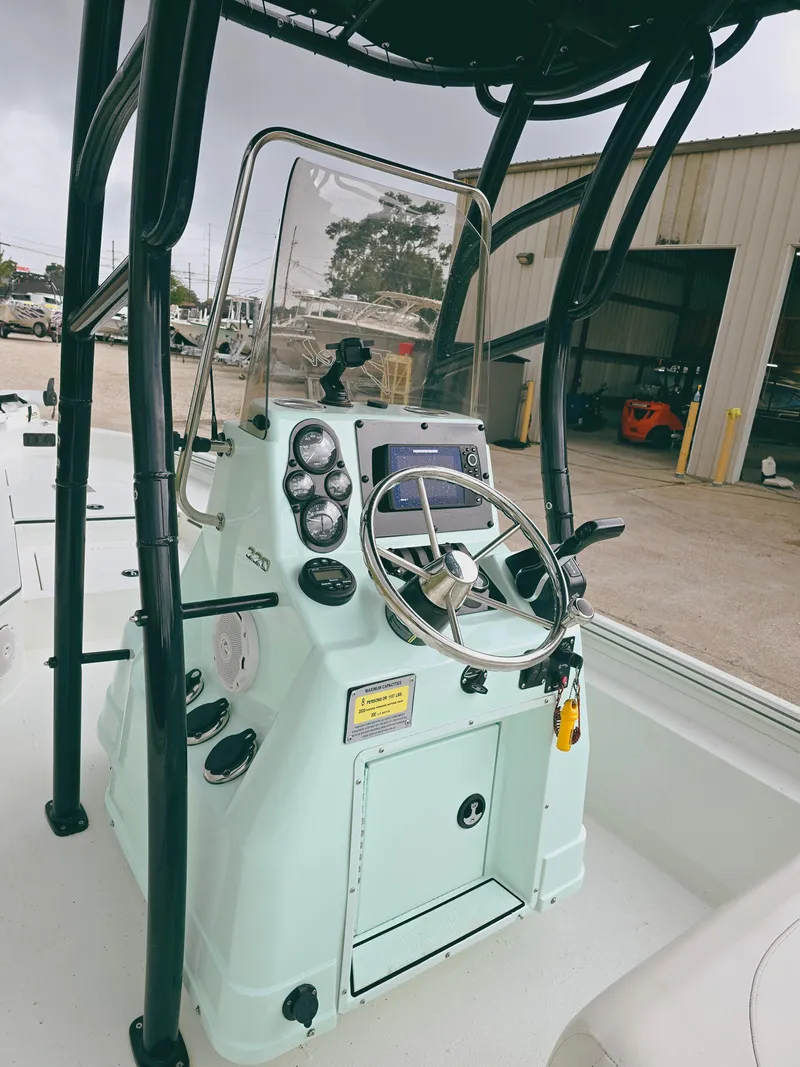 Slide: The Image of 2021 Excel Bay Pro boat console with steering wheel and gauges. - 11