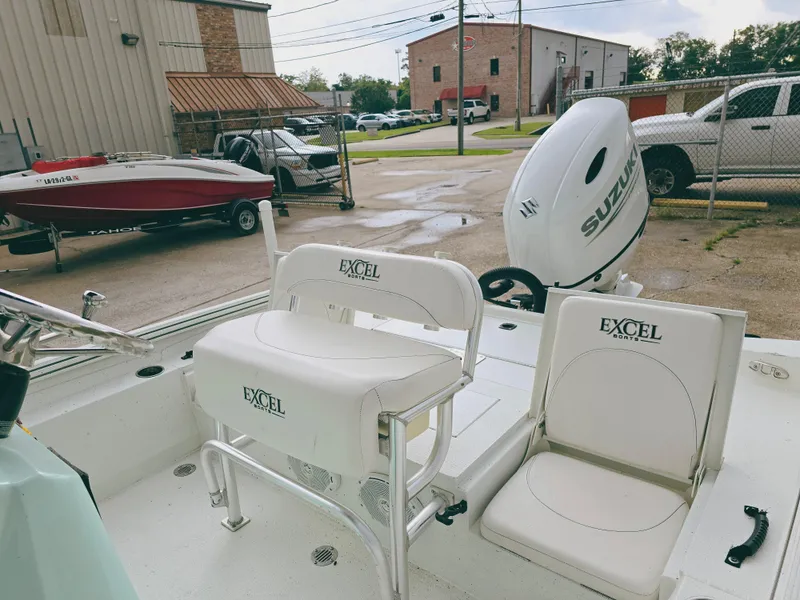 Slide: The Image of 2021 Excel Bay Pro boat with Suzuki outboard motor in a parking lot. - 12