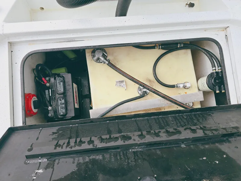 Slide: The Image of 2021 Excel Bay Pro boat battery and fuel system compartment. - 14
