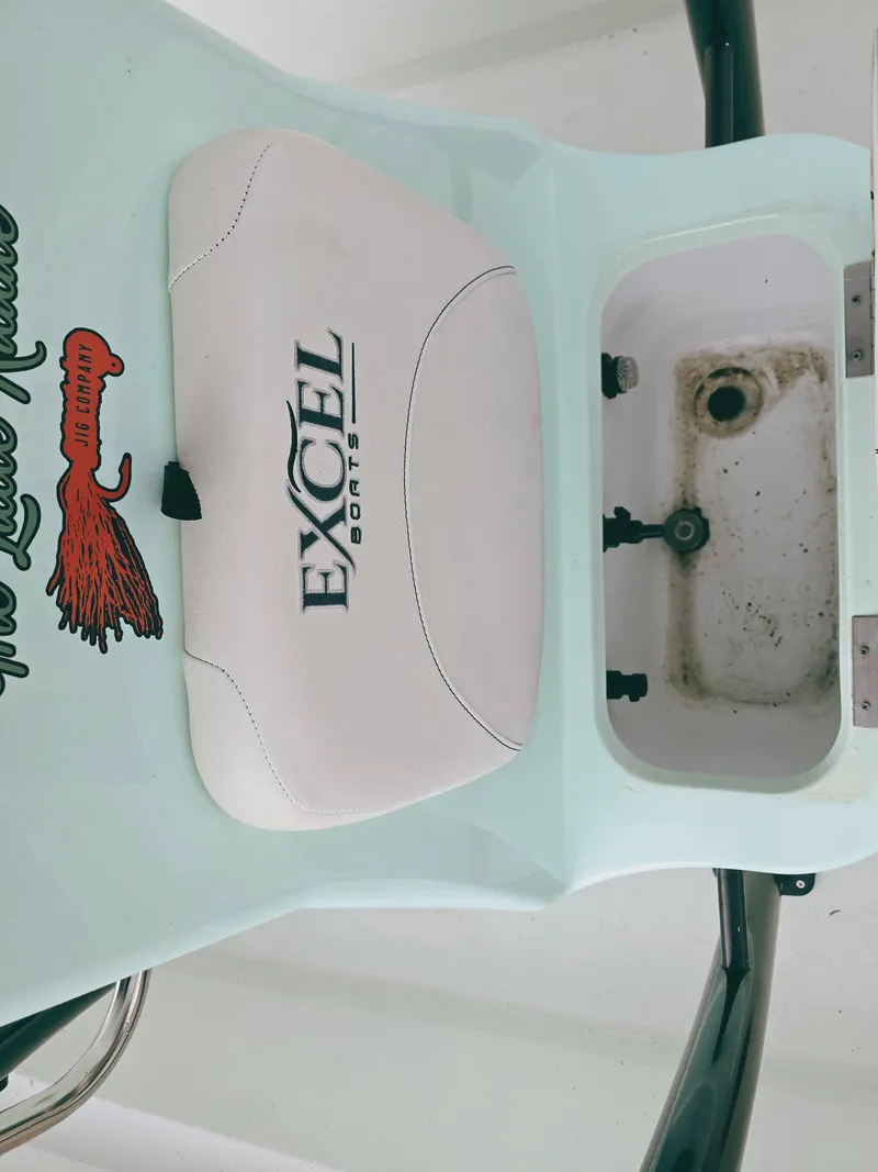 Slide: The Image of 2021 Excel Bay Pro boat seat with logo and storage compartment. - 16