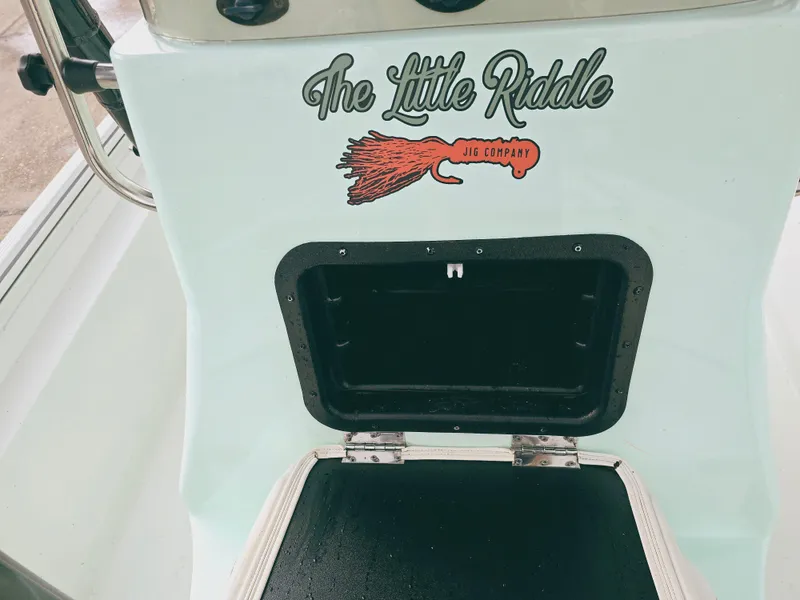 Slide: The Image of 2021 Excel Bay Pro boat with "The Little Riddle" logo and storage compartment. - 17