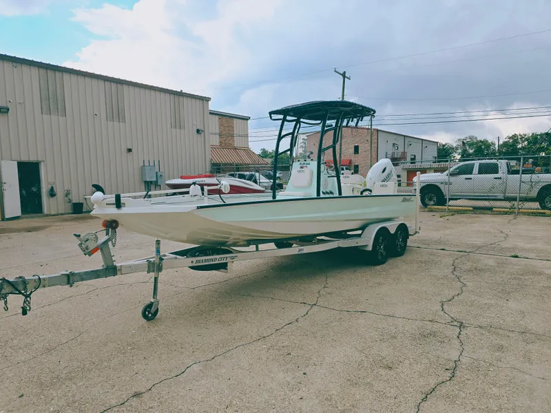 Slide: The Image of 2021 Excel Bay Pro boat on trailer in industrial lot. - 3