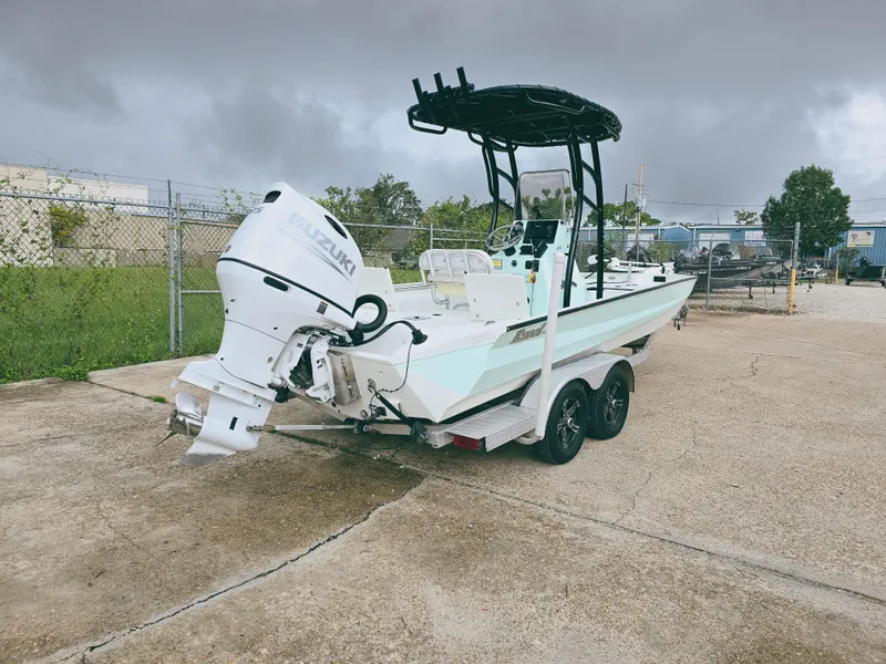 Slide: The Image of 2021 Excel Bay Pro boat with Suzuki outboard motor on trailer. - 5