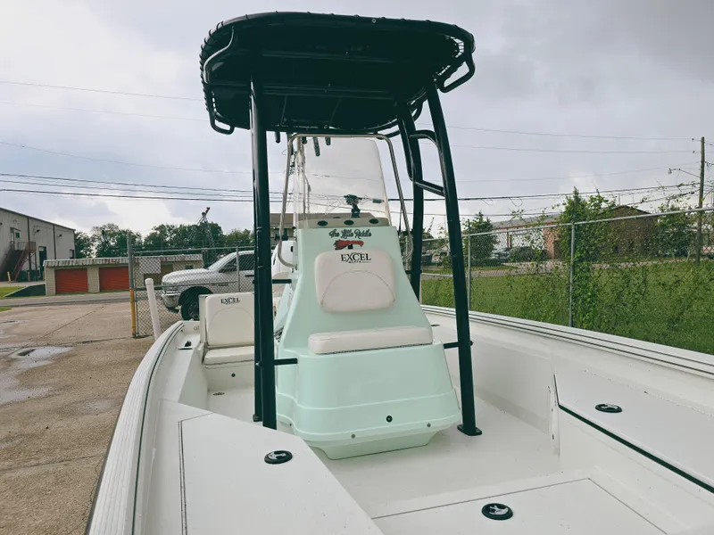 Slide: The Image of 2021 Excel Bay Pro boat with T-top, parked outdoors on a cloudy day. - 8