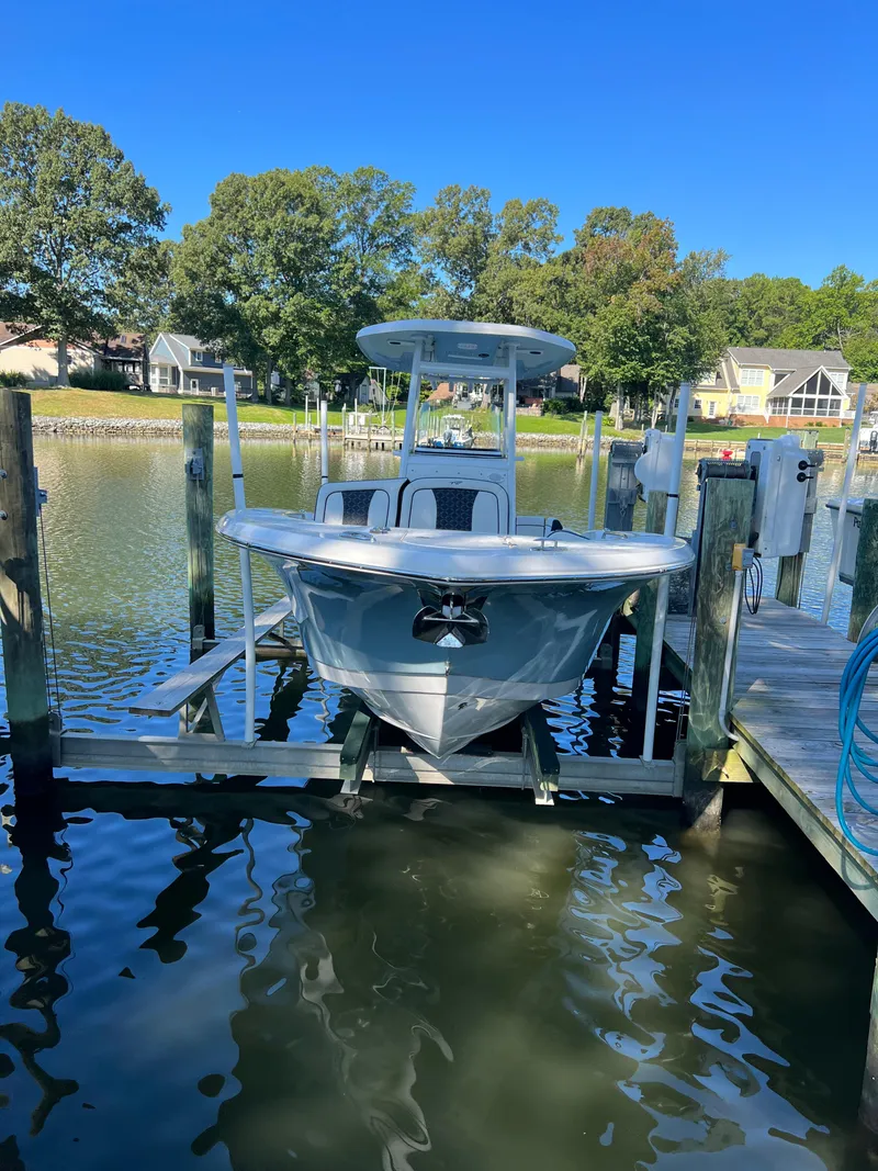 Slide: The Image of 2021 Tidewater 232 LXF boat docked on a sunny day by the waterfront. - 3
