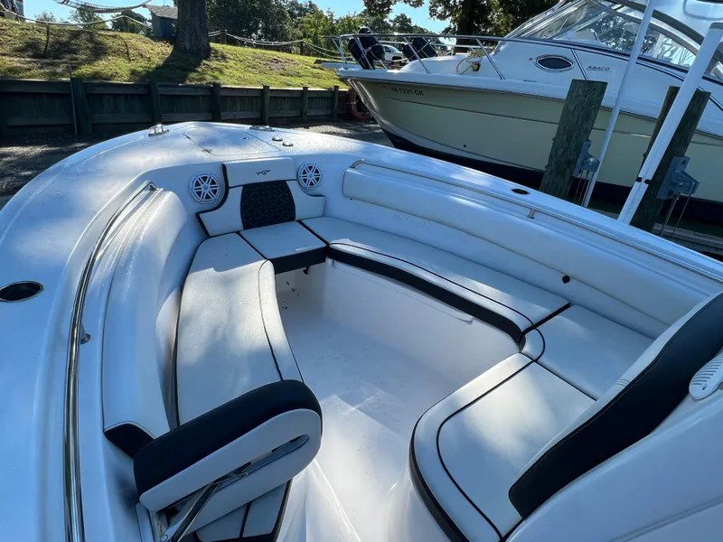Slide: The Image of 2021 Tidewater 232 LXF boat interior with white seating and speakers. - 4