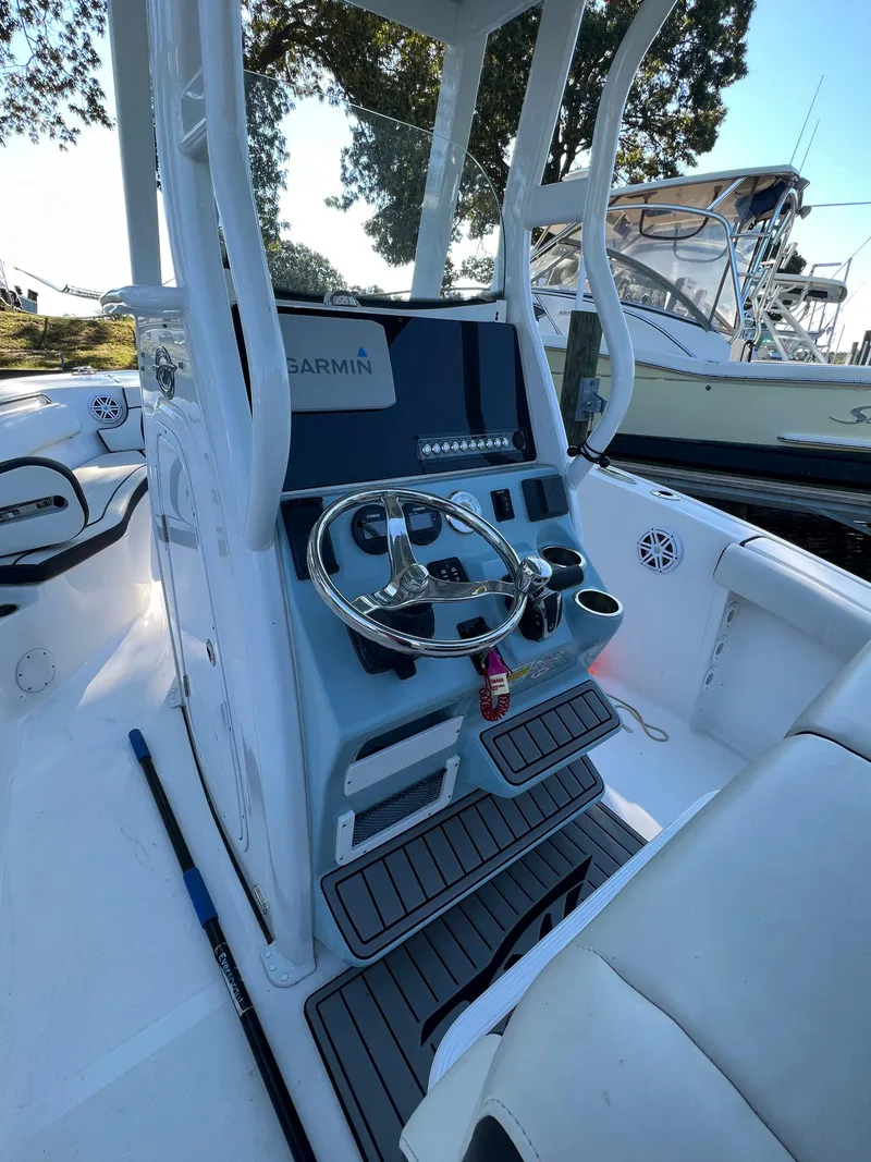 Slide: The Image of 2021 Tidewater 232 LXF boat console with Garmin navigation and steering wheel. - 6