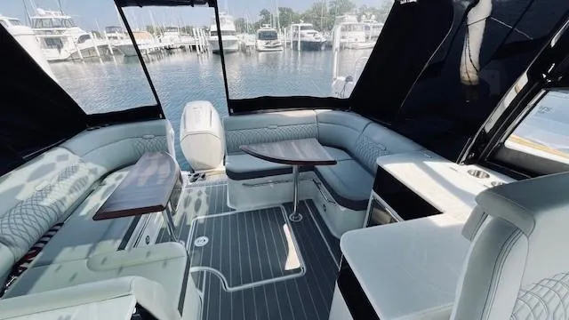 Slide: The Image of 2023 Sea Ray 370 Sundancer interior with elegant seating and waterfront view. - 12