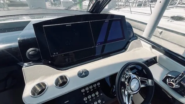 Slide: The Image of 2023 Sea Ray 370 Sundancer helm with dual screens and modern controls. - 13