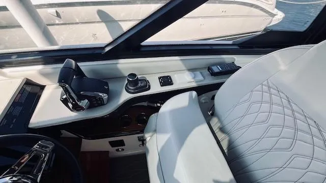 Slide: The Image of 2023 Sea Ray 370 Sundancer helm with modern controls and luxurious seating. - 14