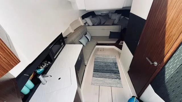 Slide: The Image of Interior of 2023 Sea Ray 370 Sundancer yacht, featuring modern design and cozy seating area. - 18