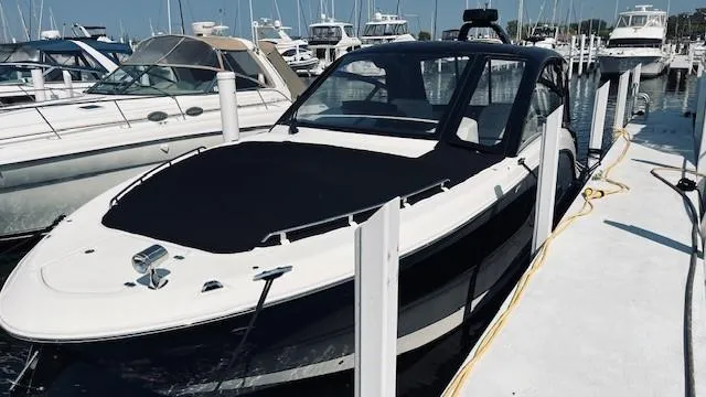 Slide: The Image of 2023 Sea Ray 370 Sundancer docked at marina, sleek design, luxury boat. - 2