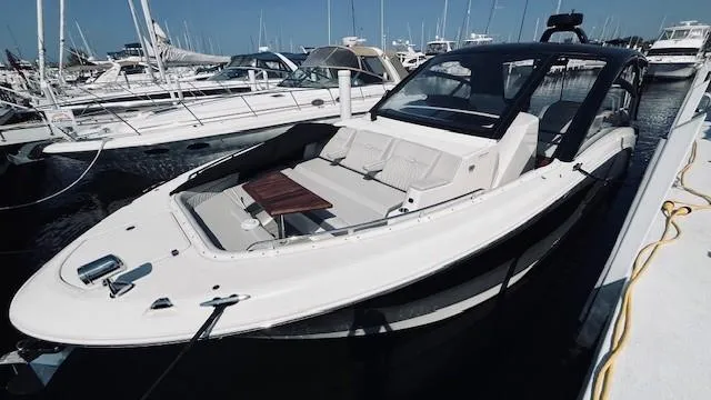 Slide: The Image of 2023 Sea Ray 370 Sundancer yacht docked at marina, showcasing sleek design and luxury features. - 3