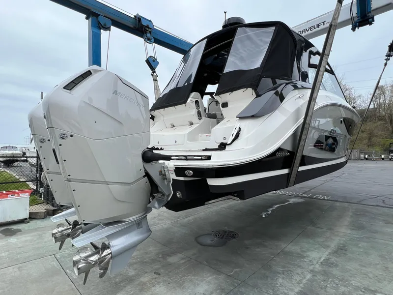 Slide: The Image of 2023 Sea Ray 370 Sundancer boat with powerful outboard engines on a lift. - 32