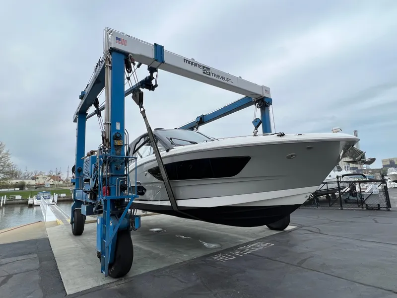 Slide: The Image of 2023 Sea Ray 370 Sundancer yacht on a lift at a marina. - 33