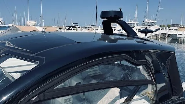 Slide: The Image of 2023 Sea Ray 370 Sundancer yacht docked at marina, showcasing sleek design and modern features. - 8