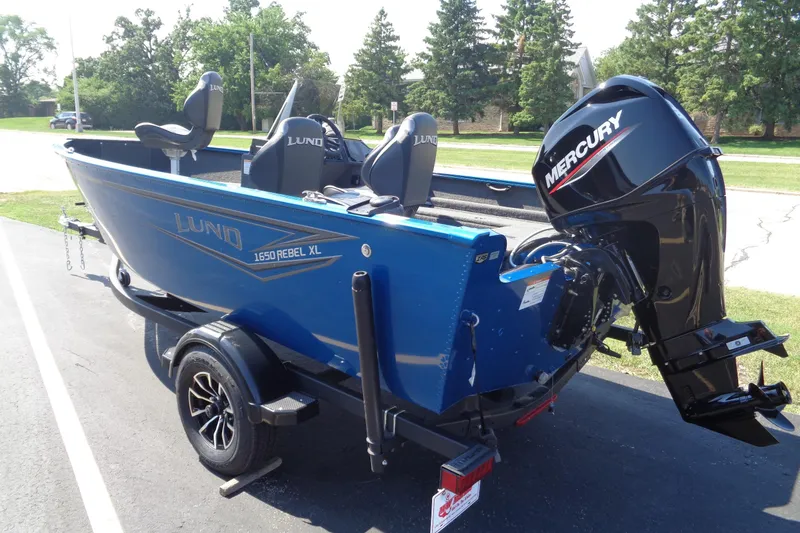 Slide: The Image of 2025 Lund 1650 Rebel XL SS boat with Mercury outboard engine on trailer. - 2