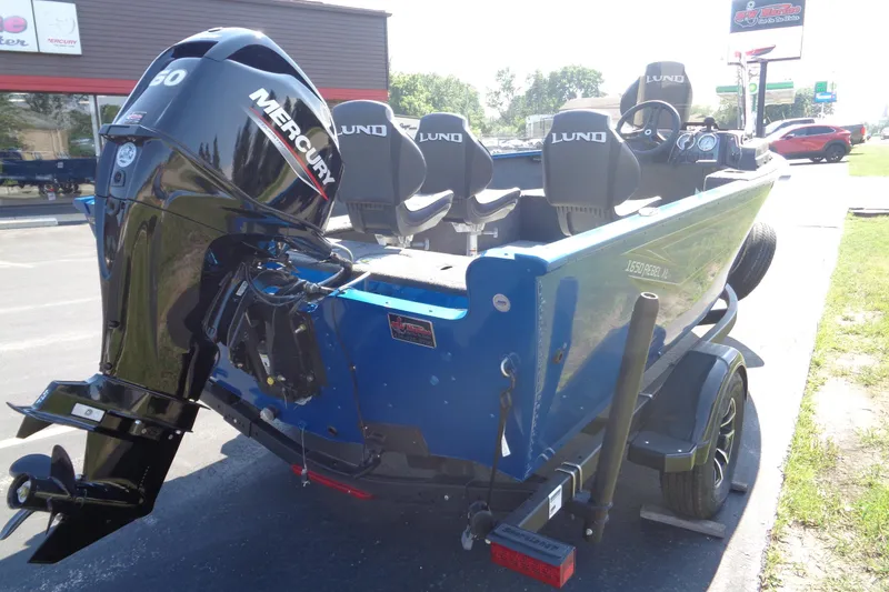 Slide: The Image of 2025 Lund 1650 Rebel XL SS boat with Mercury engine, parked outdoors. - 5