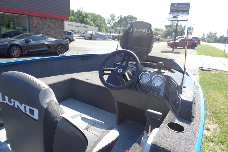 Slide: The Image of 2025 Lund 1650 Rebel XL SS boat interior with steering wheel and dashboard gauges. - 7
