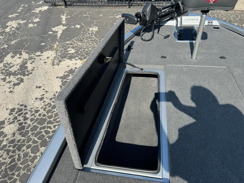 Slide: The Image of 2025 Vexus AVX1980 boat deck with open storage compartment and trolling motor. - 23