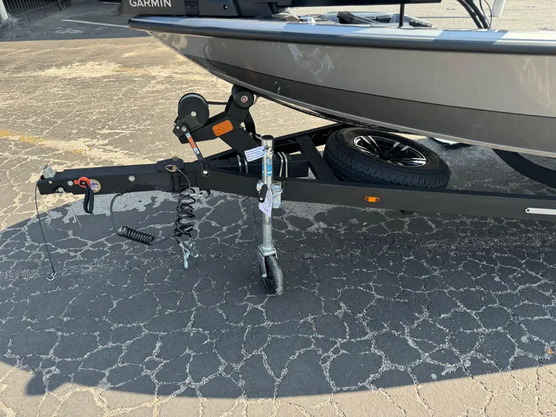 Slide: The Image of 2025 Vexus AVX1980 boat trailer with hitch and spare tire on cracked pavement. - 6