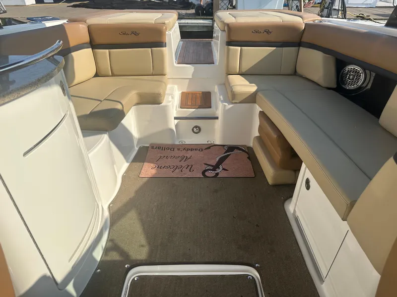 Slide: The Image of Interior of a 2014 Sea Ray 270 SLX boat with tan seating and carpeted floor. - 10