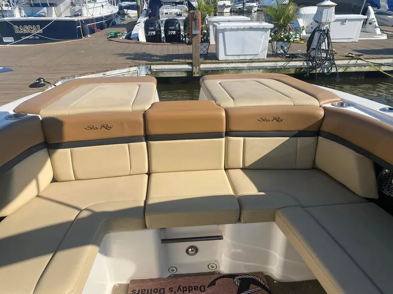 Slide: The Image of 2014 Sea Ray 270 SLX boat interior with tan leather seating at marina. - 7