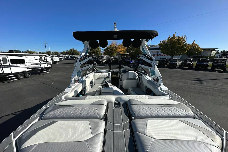 Slide: The Image of 2024 Centurion Ri230 boat interior with plush seating and sleek design in outdoor setting. - 4