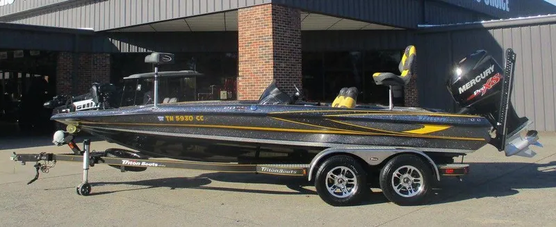 The Image of 2016 Triton 20 TRX bass boat with Mercury engine on trailer. - 1