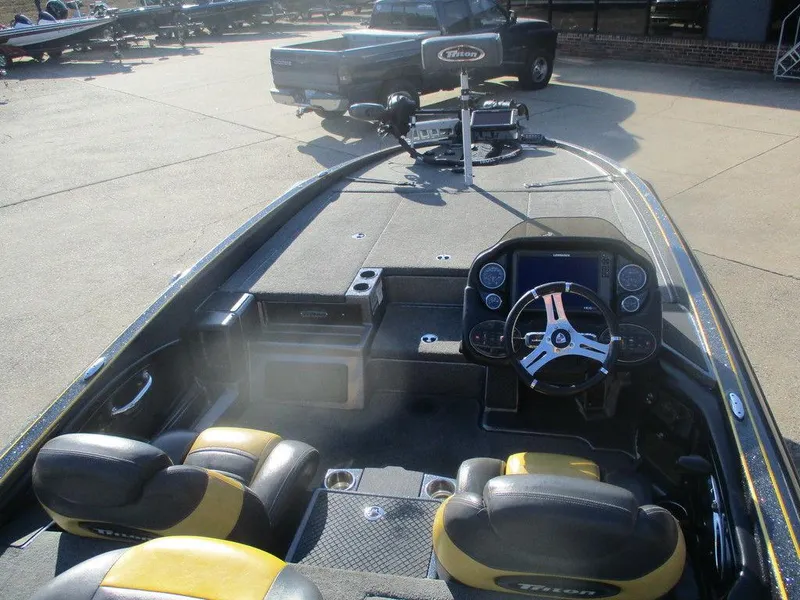 Slide: The Image of 2016 Triton 20 TRX boat interior with steering wheel and seating. - 10