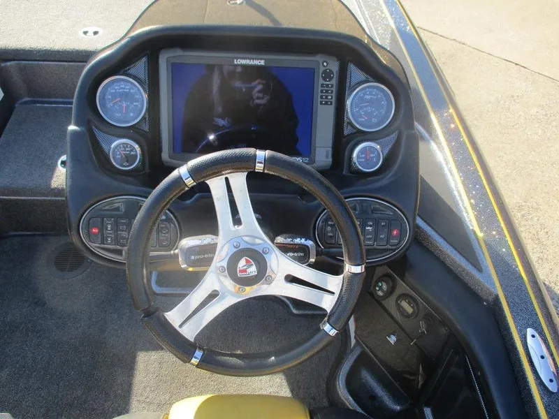 Slide: The Image of 2016 Triton 20 TRX boat dashboard with steering wheel and electronic display. - 9