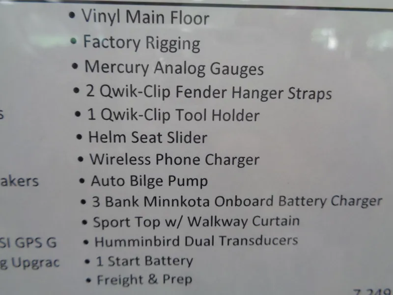 Slide: The Image of 2024 Lund 1650 Angler SS boat interior with two seats and steering console. - 12