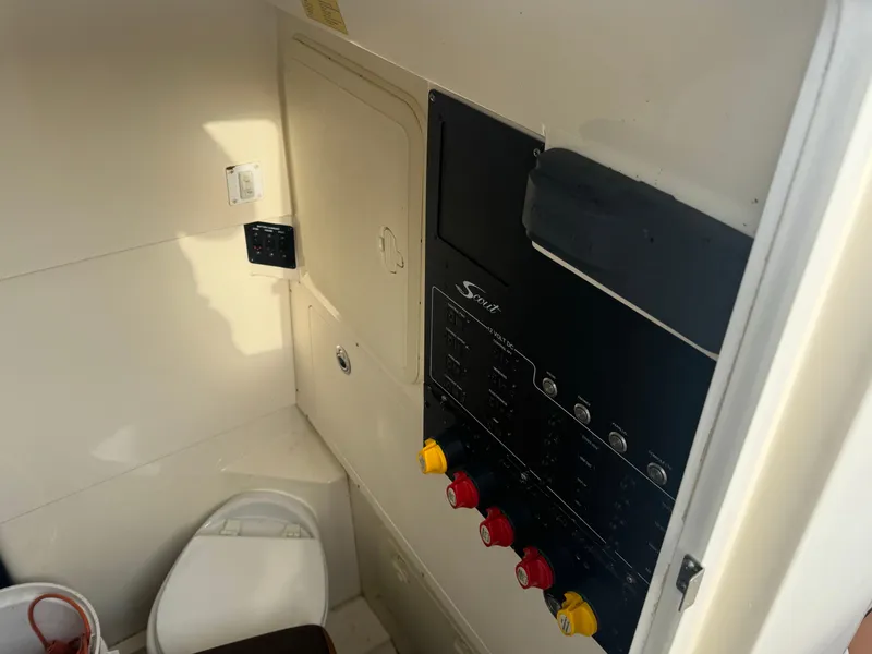 Slide: The Image of 2015 Scout 320 LXF boat interior with control panel and toilet. - 6