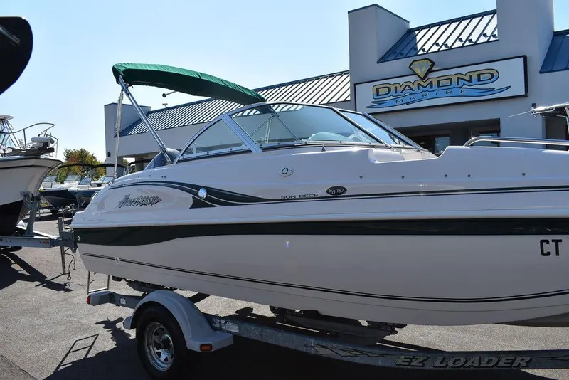 Slide: The Image of 2003 Hurricane SD 187 boat on trailer outside dealership. - 10