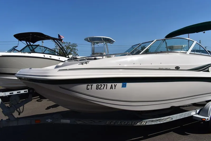 Slide: The Image of 2003 Hurricane SD 187 boat on trailer, side view, clear sky background. - 11