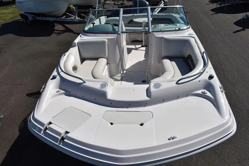 Slide: The Image of 2003 Hurricane SD 187 boat with white seating and windshield, parked on asphalt. - 13