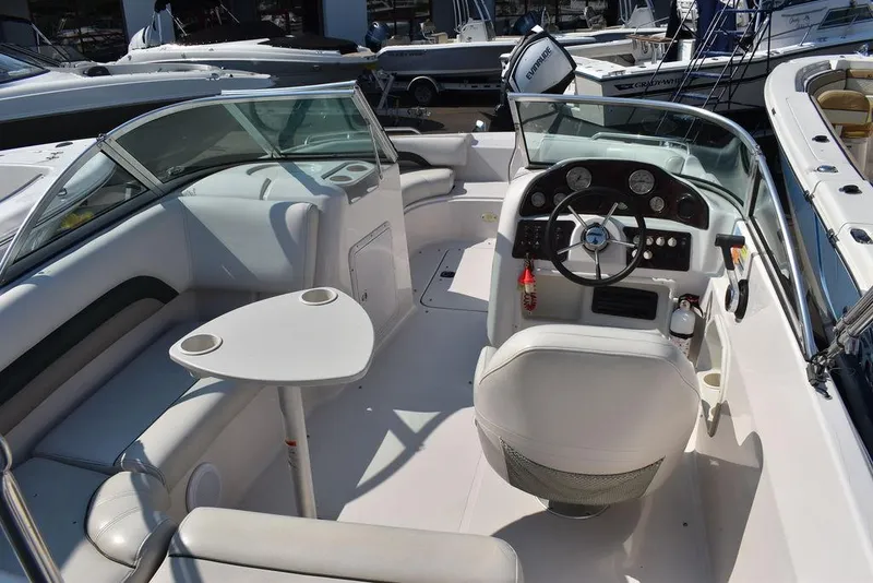 Slide: The Image of 2003 Hurricane SD 187 boat interior with steering wheel and seating area. - 16