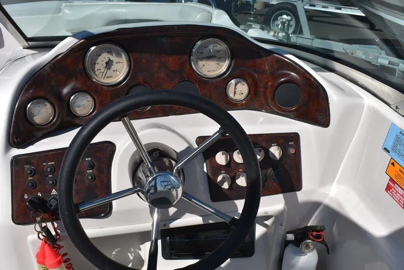 Slide: The Image of Steering console of 2003 Hurricane SD 187 boat with gauges and controls. - 17