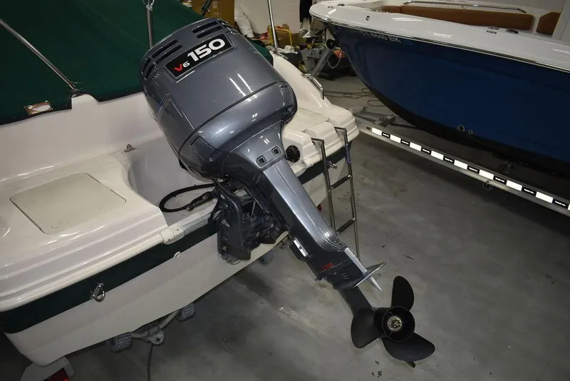 Slide: The Image of Outboard motor on a 2003 Hurricane SD 187 boat in a garage setting. - 21