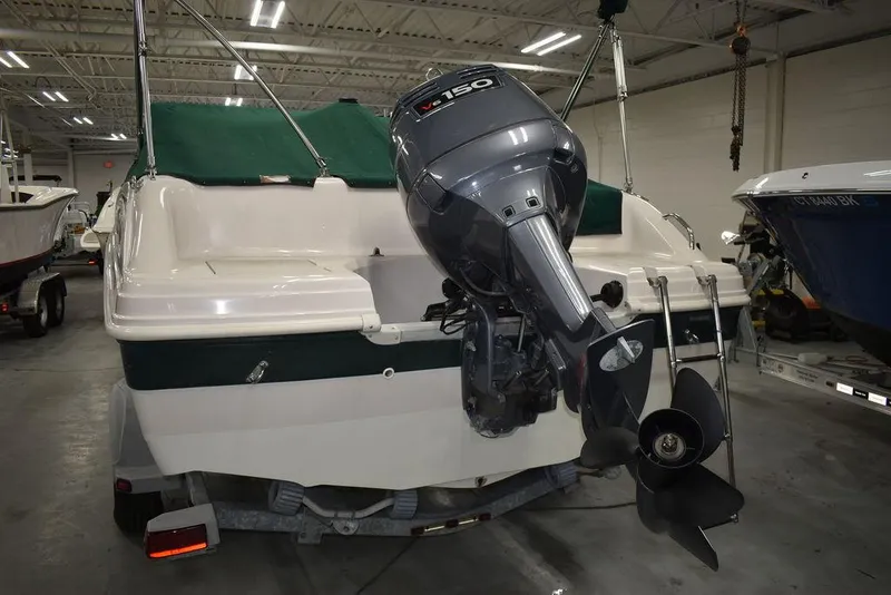 Slide: The Image of 2003 Hurricane SD 187 boat with outboard motor in indoor storage. - 22