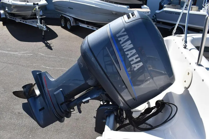 Slide: The Image of Yamaha outboard motor on 2003 Hurricane SD 187 boat, parked in marina. - 23