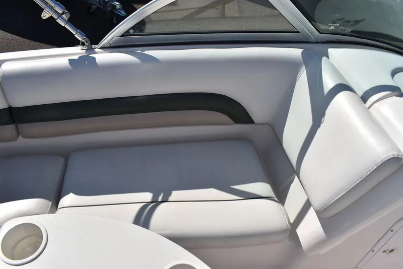 Slide: The Image of 2003 Hurricane SD 187 boat interior with white cushioned seating and cup holders. - 24